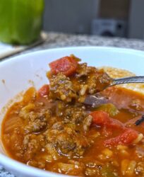 stuffed pepper soup in a white bowl on a kitchen counter